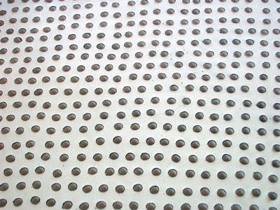 sculpture plaster and graphite grid of holes
